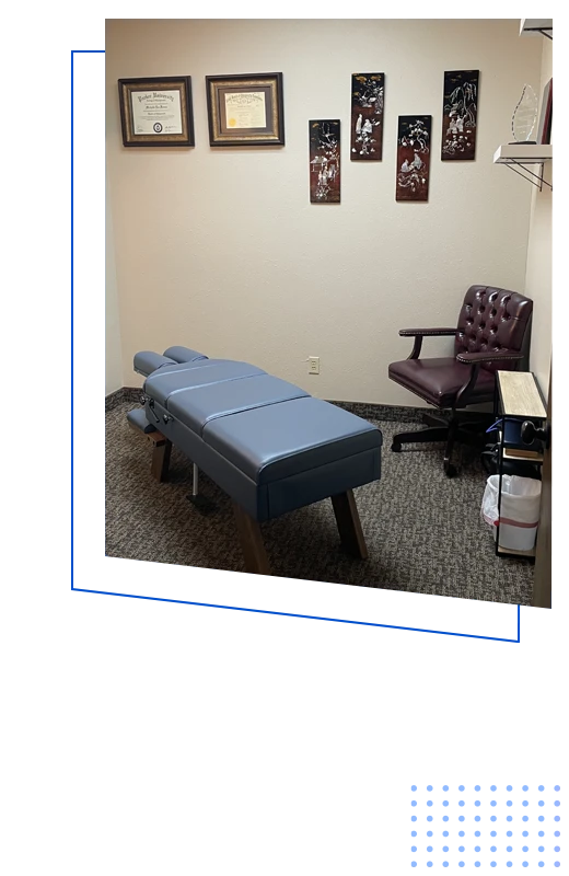 An examination room and adjustment table inside Freeze Chiropractic